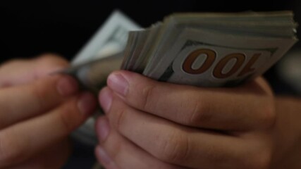 Hands counting US Dollar bills or paying in cash on money background. Concept of investment, success, financial prospects or career advancement. Para sayma.