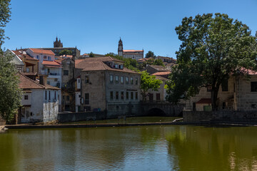 Fototapeta na wymiar View at the Viseu city downtown, with the Paiva river , classic buildings and Cathedral of Viseu and Church of Mercy on top