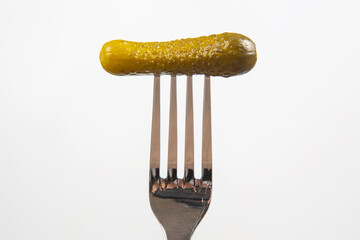 pickled cucumber on a fork. food and vegetables