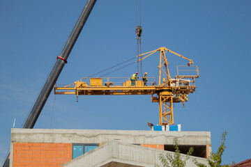 Fototapeta na wymiar Dismantling and assembling a construction crane