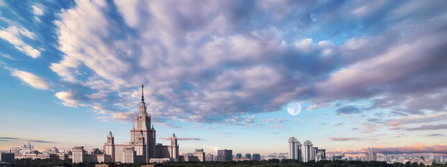 Aerial view of dramatic cloudy sky over main building of old university in sunset Moscow
