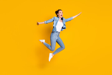 Fototapeta na wymiar Full length body size view of her she attractive lovely slim careless cheerful cheery girl jumping having fun enjoying weekend vacation isolated bright vivid shine vibrant yellow color background