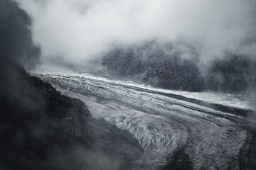 moody and dark  scenery on Aletsch Glacier an a cloudy and rainy day