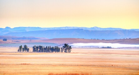 WINTER COLOURS  across farmlands and fields in the Umzimkulu valley, foothills of the southern drakensberg, kwazulu natal, south africa © wolfavni