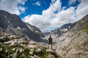 Fototapeta na wymiar hiker enjoying the view over Oberaletsch Glacier in the Swiss Alps