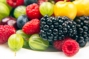 Assorted fresh different berries on a white background. useful vitamin healthy food fruit. healthy vegetable breakfast