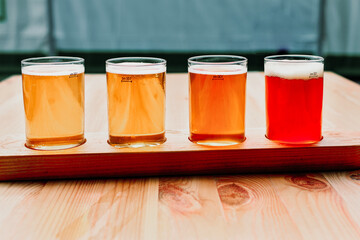 Beer tasting. Diferent beer in 100 mililiter glases over wooden table.