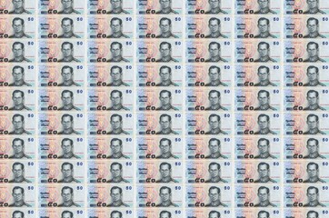50 Thai Baht bills printed in money production conveyor. Collage of many bills. Concept of currency...