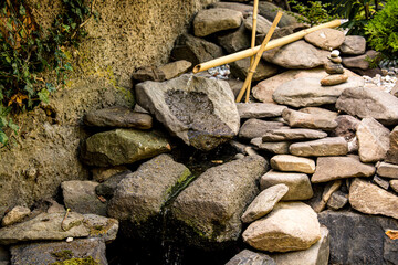Bamboo water feature and stones in the garden