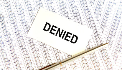 Obraz premium In the business card is the inscription DENIED, next to the pen pointing to the word, glasses and graphics.