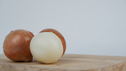  Fresh onion bulbs isolated on cutting board white background.