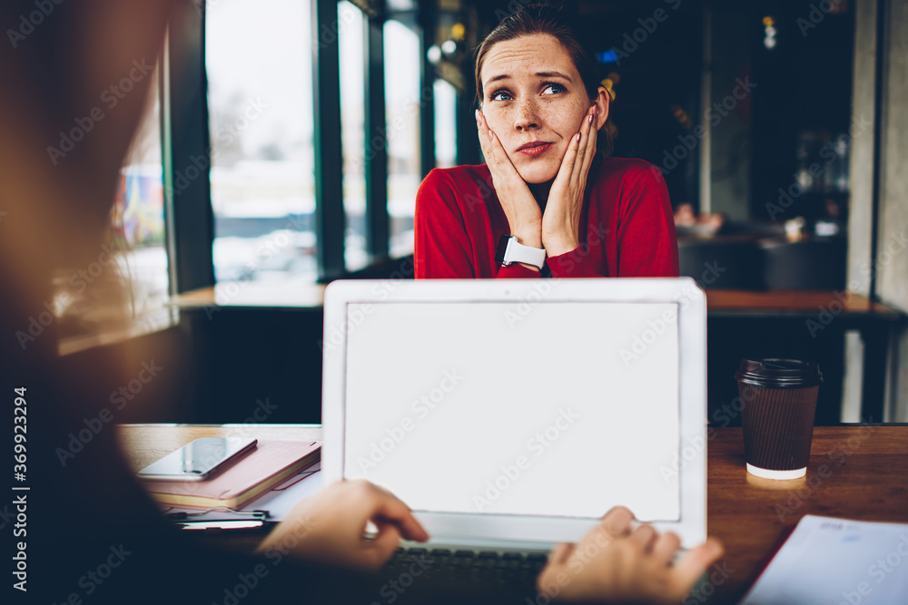 Poster puzzled female blogger thinking on solving problem and developing website working remotely while col