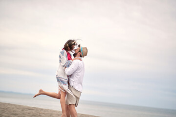 Fototapeta na wymiar beardy guy hugging his girlfriend, lifting her up