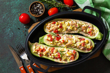 Healthy food. Baked zucchini stuffed with meat and tomatoes in a cast iron pan. Top view flat lay background. Copy space.