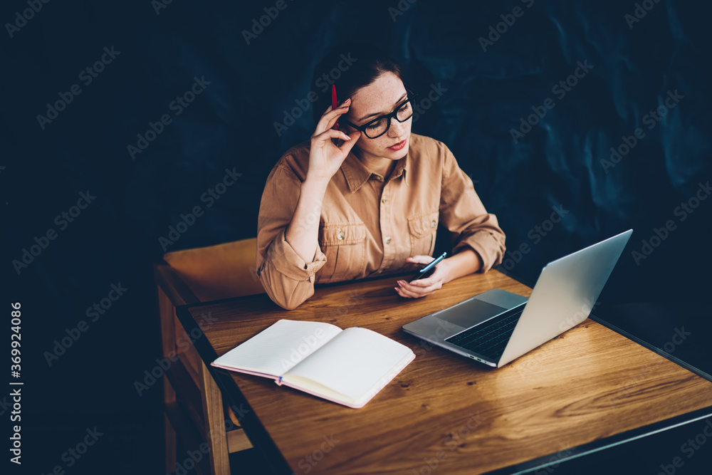 Aufkleber pensive hipster student reading information on websites and preparing for exam at laptop device conn