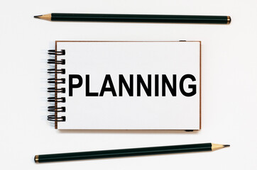 WHITE SPIRAL NOTEBOOK, TWO PENCILS WITH TEXT PLANNING