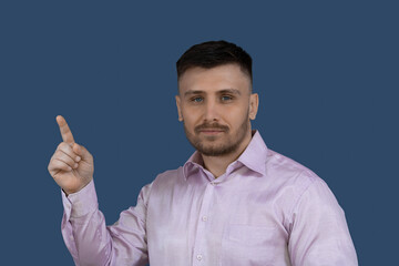 Smiling man points upward. The man points to something.