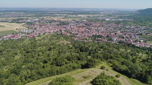Aerial shot along hill Limburg with view on city Weilheim an der Teck Germany
