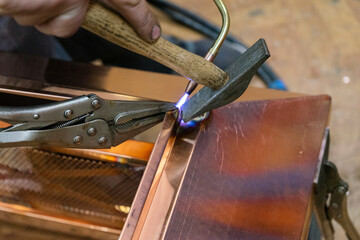 close-up of the master soldering copper