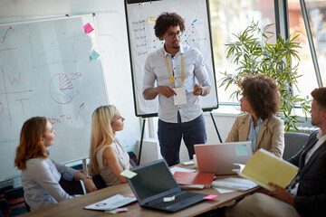 Young man leading business meeting