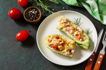 Healthy food concept. Baked zucchini with meat and tomatoes  on a stone table.