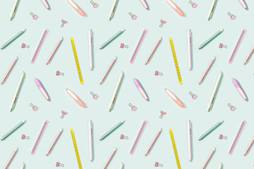 Pattern with office supplies, color pencils, pens, puler, markers and metal paper clips.