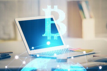 Multi exposure of blockchain theme hologram and table with computer background. Concept of bitcoin crypto currency.