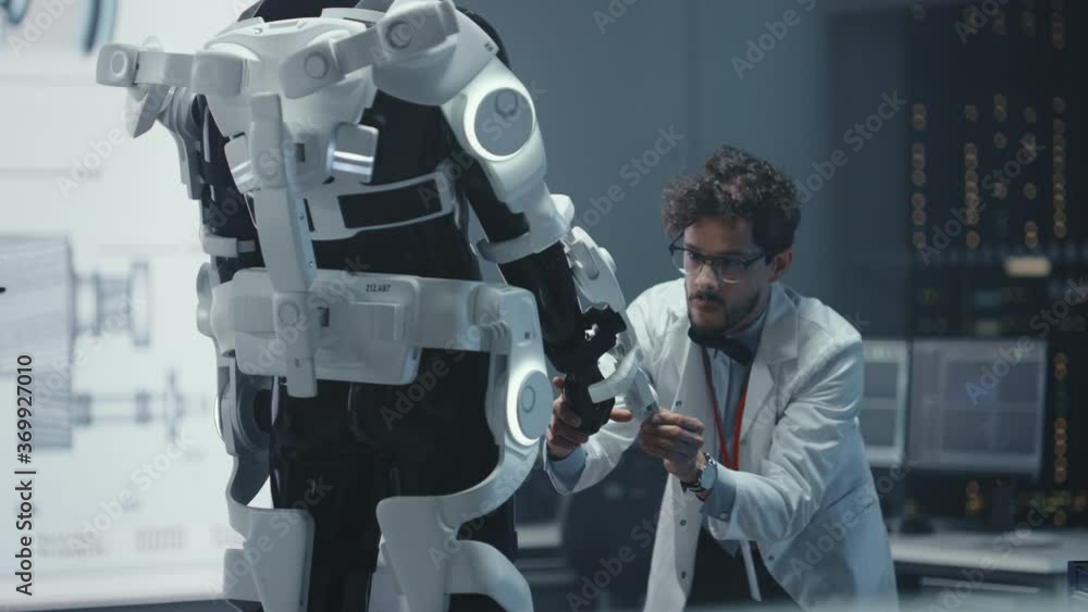 Poster in robotics development laboratory: top male scientist works on a bionics exoskeleton prototype. tea
