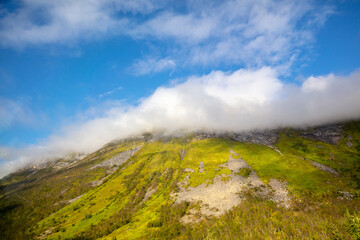 Fototapeta na wymiar Beautiful mountain peak in the clouds. Senja Island, Nature of Norway