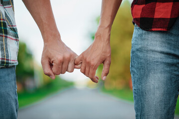 Married young loving couple holding hands each other in summer park, view of hands. Couple in love. Sensual. 