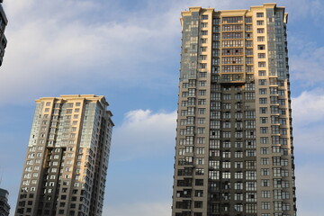 Fototapeta premium Scenic view of contemporary residential houses on a cloudy day. True modern cityscape of the Ukrainian capital. Design of contemporary build in big city. Real urban style of residential building.
