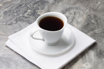 Natural drink chicory in a white Cup and saucer on napkin. Concept of the morning