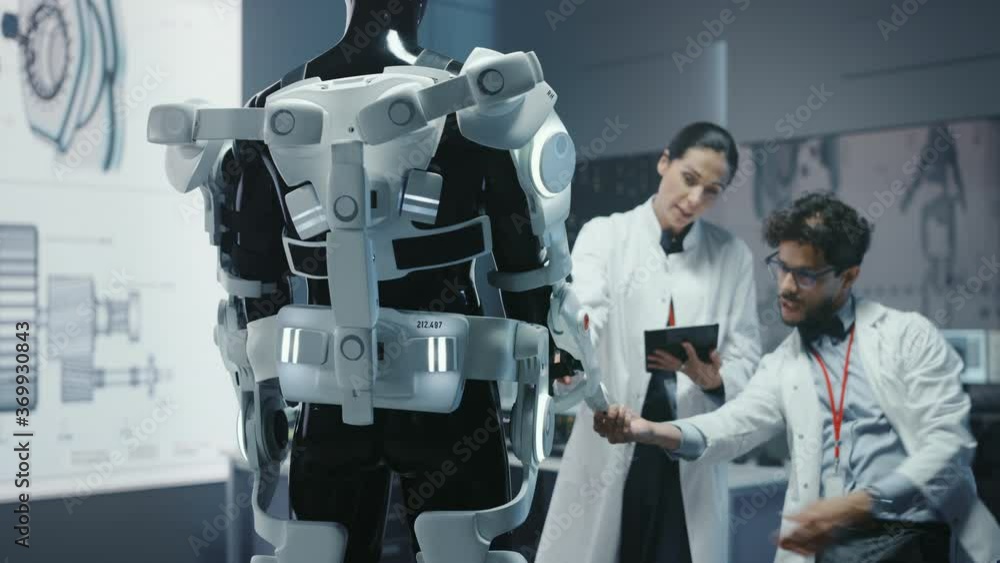 Poster in robotics development laboratory: chief female engineer and top male scientist work on a bionics e