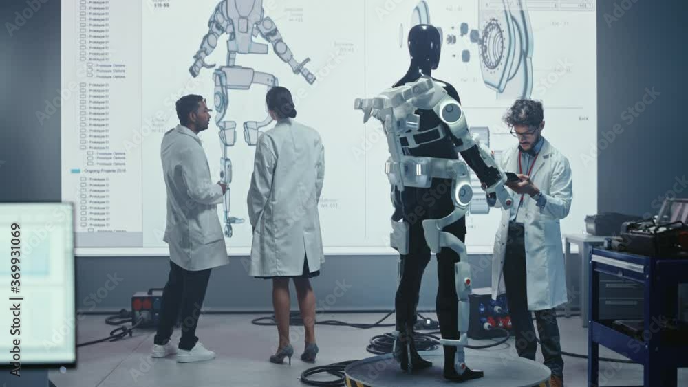 Aufkleber In Robotics Development Laboratory: Female Engineer and Male Scientist Work With Big Screen Showing Robotics Exoskeleton Prototype Design. Building Exosuit to Help Disabled People, Hard Labor Workers
