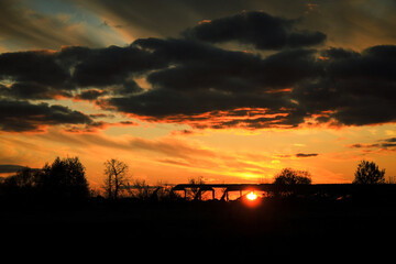 beautiful orange sunset with grey clouds in autumn