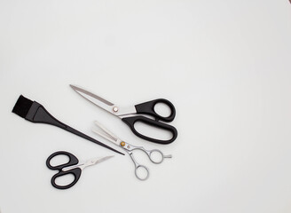 Hairdressing set on a white background. Hairdressing scissors, hair brush. Hairdressing tools.