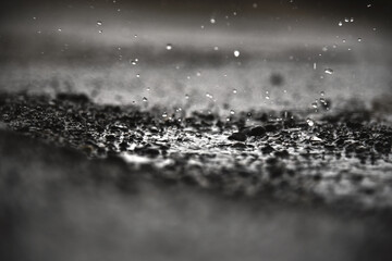Rain water drops on rain water and soil field.