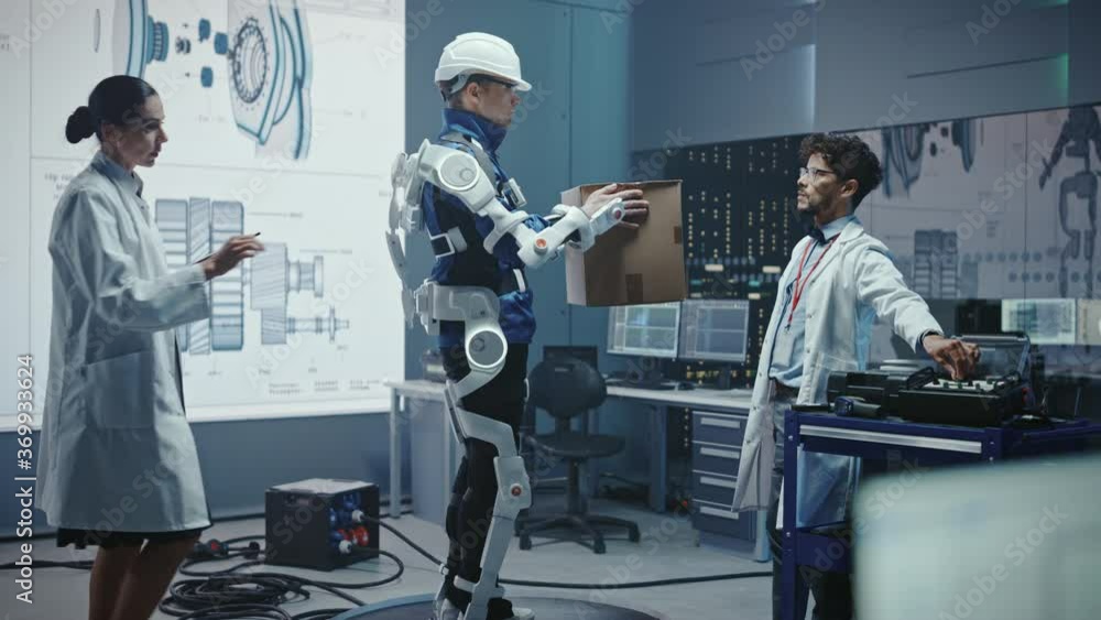 Aufkleber In Development Laboratory: Engineers Work on a Robotic Exoskeleton with a Person Testing it by Trying to Lift Heavy Cardboard Box. Designing Wearable Exosuit to Help Hard Labor Warehouse Workers