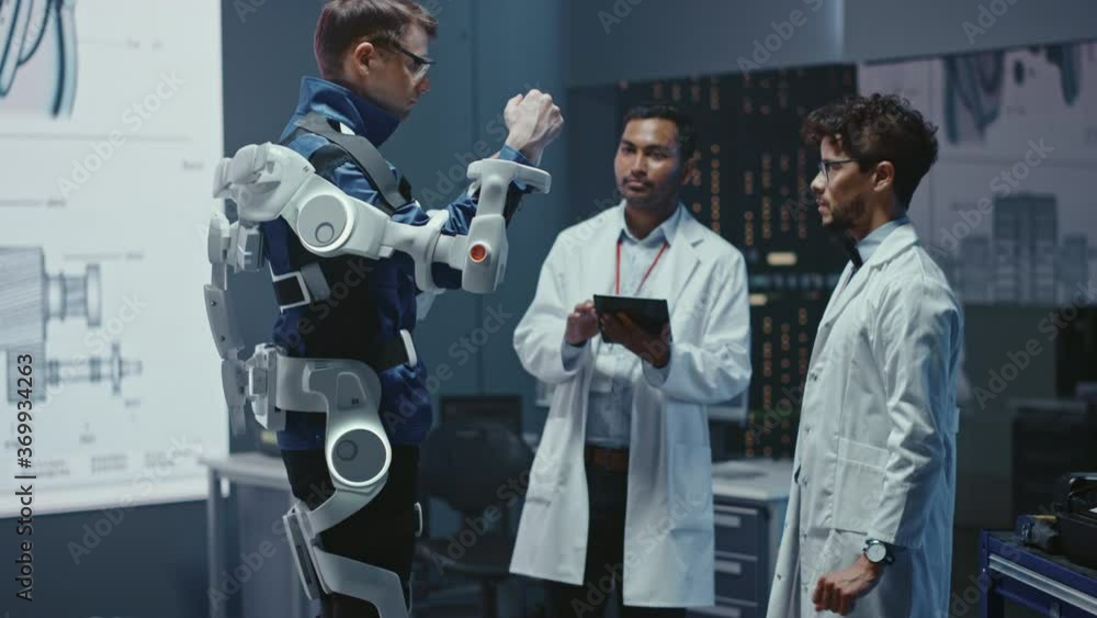 Poster in robotics development laboratory: engineers and scientists work on a bionics exoskeleton prototype