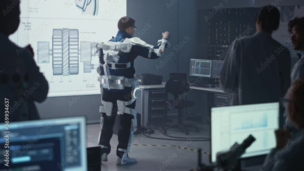 Leinwandbilder In Development Laboratory: Engineers and Scientists Look at Robotics Exoskeleton Prototype Presentation with Person Testing it, Moving and Performing. Designing Wearable Exosuit to Help People