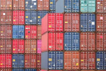 Four rows of vertical containers of different colors in the port