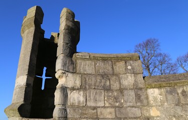 A tower with arrow slit in a section of the ancient, historic York City wall.