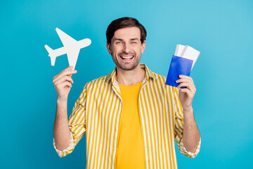 Yeah borders open. Positive cheerful man hold paper card plane tickets enjoy travel abroad covid...