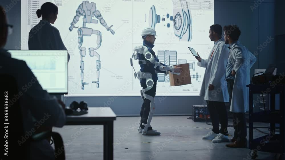 Aufkleber In Development Laboratory: Engineers Look at Robotics Exoskeleton Prototype Presentation with Person Testing it, Lifting Heavy Carboard Box. Designing Wearable Exosuit to Help Warehouse Workers