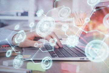 Social network theme hologram with businessman working on computer on background. Concept of world wide web. Multi exposure.