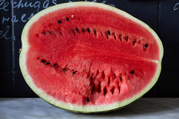 Half a ripe red watermelon on the table