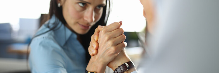 Man and woman are fighting in office in their arms. Feminis and business competition concept