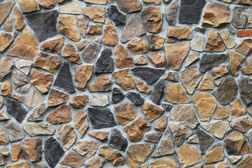 colorful odd shaped tan black natural stone block wall