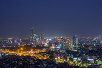 Fototapeta na wymiar Cityscape of Hanoi skyline in Cau Giay district by Cau Giay park during sunset time in Hanoi city, Vietnam