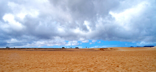 
Road through the desert, sand dunes and beautiful clouds. Dunas de Corralejo, Fuerteventura, Canari Islands